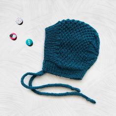 "❤️ 𝗗𝗘𝗧𝗔𝗜𝗟𝗦 This teal winter toddler bonnet hat is perfect for your little one stay warm and stylish through the cold days! A handmade bonnet hat with a simple, yet lovely, pattern that your toddler will love to wear. This kids knit hat closes tightening a bow with the crochet ribbon around your kid's neck. ⭐️ 𝗙𝗘𝗔𝗧𝗨𝗥𝗘𝗦 - Handmade knit bonnet - Season: WINTER - Yarn (100% acrylic) - Colour: pick your favorite color from the \"select a color\" option. The color chart is in the pictures above. - Production Method: Knit - ID number: NGB0574 - Sizes (measure the circumference around the head): 2-3 years: 19-20\" (48-50cm) 3-5 years: 20-20,5\" (50-52cm) 5-8 years: 20,5-22\" (52-56cm) ✈️ MADE TO ORDER: one item has a processing time of 4 to 6 weeks --------------------------------- Playful Warm Bonnet Cap, Handmade Playful Winter Bonnet, Playful Handmade Winter Bonnet, Adjustable Knitted Bonnet, Handmade Winter Bonnet As A Gift, Handmade Winter Bonnet As Gift, Handmade Winter Bonnet Gift, Handmade Adjustable Beanie Bonnet, Handmade Winter Bonnet Cap