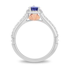 a white gold ring with an orange and blue stone in the center, surrounded by diamonds