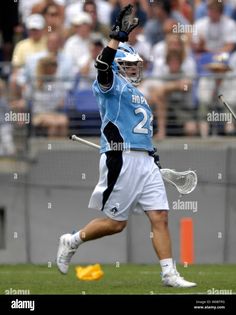 a lacrosse player in action on the field during a game - stock image