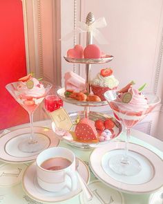 a table topped with plates and cups filled with desserts