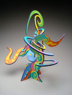 a sculpture made out of colored paper on a gray background