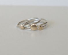 Perfect everyday Stacking Rings!Each dot ring is individually handmade from sterling silver and brass, and finished with a brushed finish. The dots are 4mm and 3mm. The three rings can be worn together or individually or stacked with other rings as well.  These rings are also available with Copper dot or Silver dots, on silver rings.Each ring can be made in different sizes if requested at checkout.Comes Gift Wrapped!++++++++++++++++++++++++++++++++++++++++++++++++++++++++++++++++MADE TO ORDERPle Silver Brass Stackable Rings For Promise, Handmade Minimalist Brass Stackable Rings, Silver Dainty Brass Rings, Dainty Silver Brass Rings, Handmade Sterling Silver Stackable Rings In Yellow Gold, Handmade Gold Stackable Rings In Sterling Silver, Rings Silver And Gold, Stacking Rings Silver, Rings Minimal