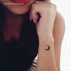 a woman with a crescent tattoo on her wrist