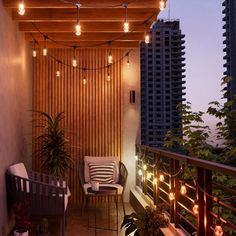 the balcony is decorated with string lights and chairs