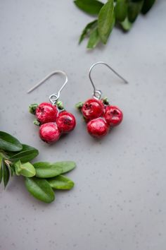 Add a touch of autumn to your style with our Handmade Cranberry Drop Hook Earrings 🍂, crafted with love in our small Liiber Design art studio. These cranberry fruit-inspired earrings make a perfect gift for fruit lovers and vegans alike, offering a minimalist red berry charm that's both elegant and playful. Choose from dangle hook, French hook, or stud options to match your personal style. Each pair is meticulously made from polymer clay, hand-painted, and finished with a waterproof varnish for Cherry Colored Earrings For Valentine's Day Gift, Cherry Earrings For Valentine's Day Gift, Cherry Color Earrings For Valentine's Day Gift, Berry Colored Fruit Design Earrings For Gift, Berry-colored Fruit Design Earrings For Gift, Berry Colored Fruit Design Jewelry Gift, Handmade Berry Colored Earrings For Gift, Handmade Berry Earrings For Gift, Fruit Design Drop Earrings As Gift