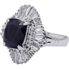 Engage with the elegance of timeless sophistication embodied in the Platinum 900 5.11 Carat No Heat Burma Sapphire Ballerina Ring. This exquisite piece exudes luxury and exclusivity, showcasing a magnificent 5.11- Carat natural Burmese sapphire as its focal point. The allure of this rare gemstone is further enhanced by a surrounding halo of 1.62 Carats of brilliant diamonds, set in lustrous Platinum 900.Imagine the captivating sparkle and deep, rich hues of the sapphire, evoking a sense of mystery and allure. The intricate ballerina setting adds a touch of whimsy and grace to the design, making it a truly unique and enchanting piece. Whether worn as a statement accessory or a symbol of love and commitment, this ring is sure to make a lasting impression.Indulge in the opulence of fine craft Luxury Sapphire Ring With Brilliant And Baguette Cuts, Luxury Gia Certified Cushion Cut Sapphire Ring, Luxury Gia Certified Baguette Cut Sapphire Ring, Luxury Gia Certified Sapphire Ring In Platinum, Luxury Gia Certified Platinum Sapphire Ring, Luxury Platinum Sapphire Ring With Cushion Cut, Luxury White Gold Cushion Cut Sapphire Ring, Luxury Sapphire Ring With Cushion Cut In Platinum, Luxury Cushion Cut Sapphire Ring In Platinum