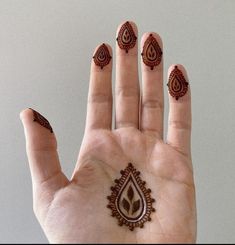 a person's hand with hendi tattoos on it