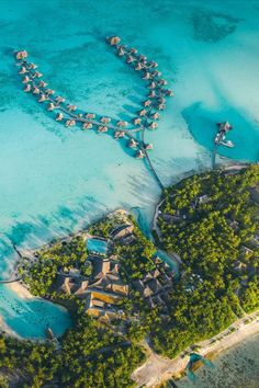 an aerial view of the resort and surrounding lagoons in the tropical island with blue water