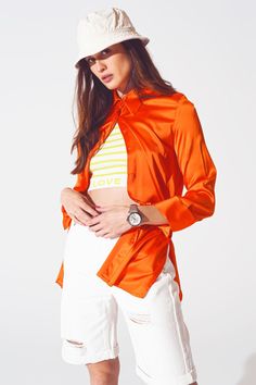 Add a touch of sophistication to your wardrobe with this Satin Shirt with Split Cuff in Orange. Made from a luxurious blend of 55% rayon, 43% viscose, and 3% spandex, this full-length shirt offers a relaxed and oversized fit, perfect for any classic occasion. The wide collar neckline and long sleeves create an elegant silhouette, while the satin fabric ensures a polished look. Designed to run true to size, our model, with measurements 33-24-35 and height 5'8", is wearing a size S. This stylish s Orange Satin, Blouse Neck, Chic And Elegant, Elegant Blouses, Classic Wardrobe, Statement Shirt, Satin Shirt, Party Fashion, Relaxed Style