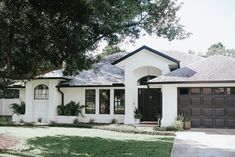 a white house with black doors and windows