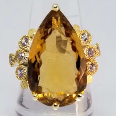 The Color Of This Citrine Is Rich, And Yummy Looking! Big, 20 Carat Authentic Unenhanced Citrine Sits Center, Surrounded By Blingy Lavender Colored Cz's. The Solid 925 Silver Is Plated In Both White And Yellow Gold. Great Statement Ring! Stamped 925 Artisan Handmade Size 8.25 Large Round Citrine Stone Jewelry, Luxury Large Stone Citrine Jewelry, Luxury Large Stone Citrine Ring, Luxury Silver Citrine Rings, Silver Multi-stone Citrine Rings, Lavender Color, Handmade Artisan, Sterling Ring, Womens Jewelry Rings