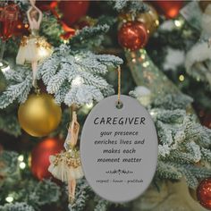 an ornament hanging from the christmas tree that says, caregiver your presence strikes and makes each moment matter