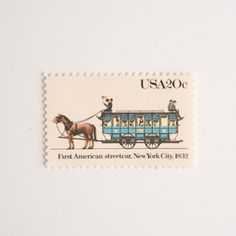 a postage stamp with an image of a horse drawn carriage on it's side