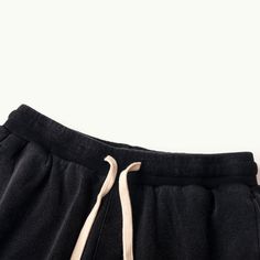 Baggy Cotton Black Cargo Shorts Beach - Raw Edge Helms - The baggy black cargo shorts are instantly eye-catching in the urban setting. Carefully crafted from 320GSM high-quality combed cotton with a breathable French Terry interior, these comfy shorts are tailored to a laid-back fit with design details that make them stand out from other cargo shorts. The side accordion pockets provide functionality and a structured look, while the distressed hem adds a rugged and edgy touch that contrasts perfe Washed Black Sweatpants With Pockets For Streetwear, Washed Black Cotton Sweatpants For Streetwear, Drawstring Cargo Shorts For Streetwear, Streetwear Drawstring Cargo Shorts, Casual Drawstring Shorts For Streetwear, Baggy Sporty Shorts For Streetwear, Sporty Baggy Shorts For Streetwear, Cotton Drawstring Shorts For Streetwear, Casual Washed Black Sweatpants With Pockets