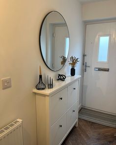 a white dresser and mirror in a room