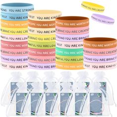 six different colored wristbands with words on them