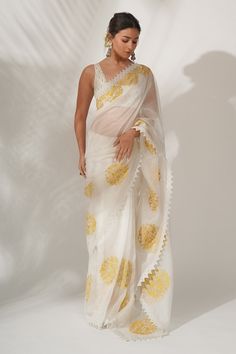 Ivory silk organza saree with resham and patra embroidery, highlighted with a cotton lace. Paired with an ivory raw silk scallop blouse enhanced with patra and sequins embroidery.
Component: 2
Pattern: Embroidered
Type Of Work: Patra, Resham work
Neckline: Scoop 
Sleeve Type: Sleeveless
Fabric: Raw Silk, Silk Organza
Color: White
Other Details: 
Lace border
Floral motifs
Embroidered blouse
Occasion: Puja,Wedding - Aza Fashions Bollywood Designer Sarees, White Saree, Embroidery Saree, Stylish Sarees, Organza Saree, Saree Look, Alia Bhatt, Silk Organza, Bollywood Saree