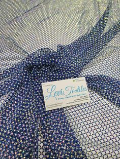 a blue and white patterned fabric with a label on it