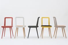 four different colored chairs in a row