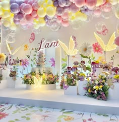 a room filled with lots of balloons and flowers