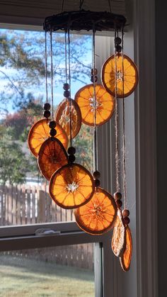 the sun is shining through the window and there are orange slices hanging from the ceiling