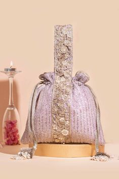 Colour: Lilac Embroidered front and back. Dimensions (LxB): 9"x 9.5" (23 cm x 24 cm) Handle drop: 6.5" (16.5 cm) Material : Embroidered georgette fabric, poly satin lining, woven golden thread drawstrings and hand-embroidered zardosi handle, gold zari tassels. Golden Thread, Diwali Gifts, Wedding Bag, Georgette Fabric, Designer Bag, Gift Wedding, Clutch Handbag, Diwali, Evening Bags