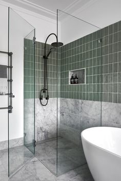 a white bath tub sitting next to a walk in shower