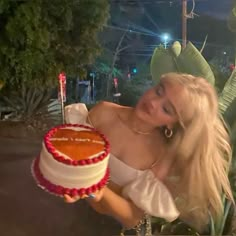 a woman holding a cake in front of her face