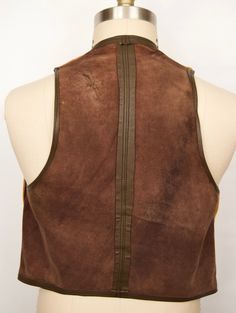 "\"The Thoroughbred\" vintage suede vest with highest level craftsmanship and leather quality you can feel. While we can't be certain whether it's calf skin, cowhide or pig skin without a label, the softness, suppleness, and thickness are evident immediately--as is the workmanship when you turn the piece inside out and see that the suede front is lined with a second layer of smooth leather with each of the leather buttons hand knotted in back (pictured 5th). Also features a rich tan or camel col Western Leather Vest For Fall, Rugged Brown Vest For Fall, Fitted Western Leather Vest, Rugged Leather Sleeveless Vest, Fitted Rugged Brown Vest, Fitted Brown Rugged Vest, Fitted Leather Vest With Rugged Style, Fitted Leather Vest In Rugged Style, Vintage Fitted Leather Vest