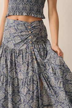 Ornate floral-print maxi skirt. Tiered ruffle design. Wide yoke waistband with ruched detail. Decorative coconut wood buttons. Side slit. High waist. A-line silhouette. Elastic-back waist. Ankle length. Relaxed fit. 100% Cotton. Imported. Designed in LA. Model wears size S. Maxi Skirt Fit, Skirt Tiered, Floral Print Maxi Skirt, Ruffle Maxi Skirt, Coconut Wood, Denim Short Dresses, Ruffle Design, Free Spirit Style, Wood Buttons