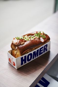 a box that has some kind of food inside of it on a wooden counter top