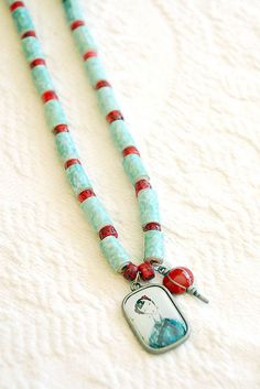 the necklace is decorated with red and blue beads