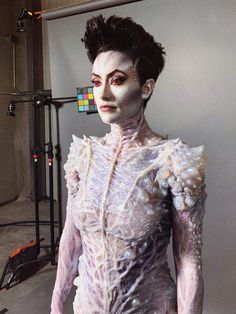 a mannequin is dressed in white and has makeup on it's face