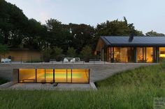 the house is surrounded by grass and trees