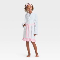 Your kid will be ready to wind down for bed in cozy style with this FAO Schwarz Hooded Robe with Headband. This white robe features a hooded design with a pink belt tie and ruffled hem, and it comes with a matching pink headband with a bow for a cute look. Made from soft knit fabric, this long-sleeve robe will be their new go-to pick for sleeping or lounging around the house. Cozy White Hooded Sleepwear, Hooded White Sleepwear For Sleepover, White Hooded Sleepwear For Sleepovers, White Winter Sleep Robe, White Hooded Sleepwear For Loungewear, White Cozy Sleep Robe, Cozy White Sleep Robe, Spring White Robe For Bedtime, White Spring Bedtime Robe