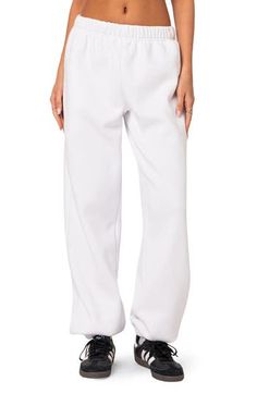 A cozy cotton blend keeps you feeling your best no matter what the day brings when you choose these oversized sweatpants. Elastic waist Side-seam pockets Elastic cuffs 50% cotton, 50% polyester Machine wash, dry flat Imported Cotton Sweats With Side Pockets For Lounging, Basic Cotton Sweats For Lounging, Comfortable White Baggy Bottoms, Baggy White Leisure Pants, White Baggy Leisure Pants, Baggy White Pants For Leisure, Comfortable Baggy White Pants, Relaxed White Bottoms With Pockets, Oversized Cotton Comfortable Joggers