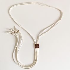 New Handmade Bolo Necklace By Western General Boutique! You Will Love The Soft Elegance Of This Necklace! It Is Absolutely Beautiful On, With Unbelievably Soft Deerskin Leather In A Creamy White Color. Each Strand Of Leather Is About 50” Long And Is Finished With Pearls And Copper Beads. Each Freshwater Pearl Bead Has A Unique Look And Shape, Giving This Necklace Gorgeous Detail. The Copper Slider Bead Is Dainty And Allows For Easy Adjustment. This Will Be Super Cute With Cutoffs Or Dresses For Wedding Fringe, Bolo Necklace, Fringe Necklace, Western Wedding, Bolo Tie, Deer Skin, Boutique Jewelry, Creamy White, Pearl Beads