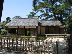 an old building with wooden fences surrounding it