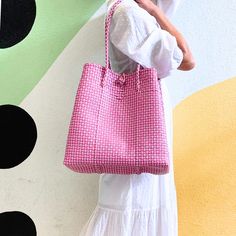 This versatile tote is a must-have accessory for all your warm-weather & cool weather adventures. Whether you're hitting the beach, the farmer’s market, lounging by the pool, or embarking on a weekend getaway, the Maxi Ella Tote has got you covered. Crafted from recycled plastic, this eco-friendly tote reduces environmental impact. Spacious enough to carry all your essentials plus more! Say hello to the perfect summer companion! Product Overview: Materials: Recycled plastic Size: 14” H (25” with Pink Square Bucket Bag For Travel, Square Pink Bucket Bag For Travel, Square Travel Bags For Spring, Everyday Square Summer Bucket Bag, Casual Square Beach Bag For Spring, Casual Spring Square Beach Bag, Pink Square Shoulder Bag For The Beach, Pink Square Bag For Summer, Chic Spring Travel Beach Bag