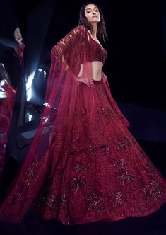 The sylvan lehenga set boasts a fully embellished design with floral and geometric artwork intricately adorned with tonal sequins and crystals. This special ensemble is exclusively crafted to enhance your unique wedding look. Designer Red Sequined Sets, Elegant Red Lehenga With Sequins, Red Embellished Party Wear Set, Glamorous Designer Dress With Intricate Embroidery, Glamorous Floor-length Sets With Intricate Embroidery, Glamorous Dresses With Dupatta For Festivals, Red Semi-stitched Sequined Lehenga, Red Party Wear Lehenga With Intricate Embroidery, Evening Lehenga With Intricate Embroidery And Traditional Drape