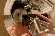 a man taking a selfie in front of a mirror with his face mask on