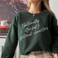 "Emotionally Attached to Fictional Characters" sweatshirt. This cozy crewneck makes a great gift for any book lover! This unisex heavy blend crewneck sweatshirt is pure comfort. These garments are made from polyester and cotton. This combination helps designs come out looking fresh and beautiful. The collar is ribbed knit, so it retains its shape even after washing. There are no itchy side seams on these sweaters.  -50% Cotton 50% Polyester\n.:  -Medium-heavy fabric  -Loose fit -Sewn in label -R Bookish Clothes, Cute Book Sweatshirts, Emotionally Attached To Fictional Characters, Literary Sweatshirt, Reading Sweatshirt