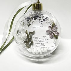 a glass ornament with flowers on it and a ribbon around the bottom that says, i love you