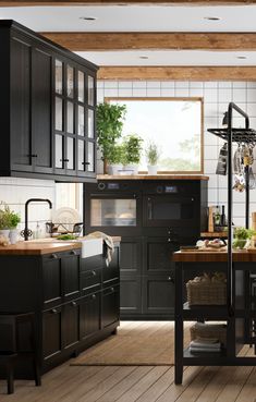 the kitchen is clean and ready for us to use it's black cabinetry