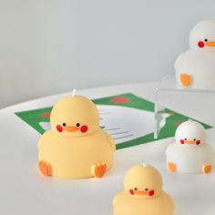 some little yellow rubber ducks sitting on a table