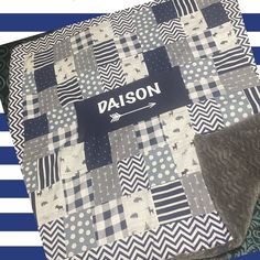 a blue and white quilt with the name daison on it