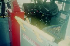 the interior of a vehicle with steering wheel and other equipment on display in front of it