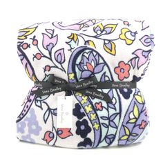 a white and purple paisley print pouch with a black ribbon on the side, sitting next to a tag that says vera bradley