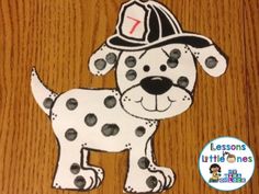 a paper cut out of a dog wearing a fire hat