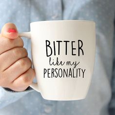 a person holding a coffee mug with the words bitter like my personality